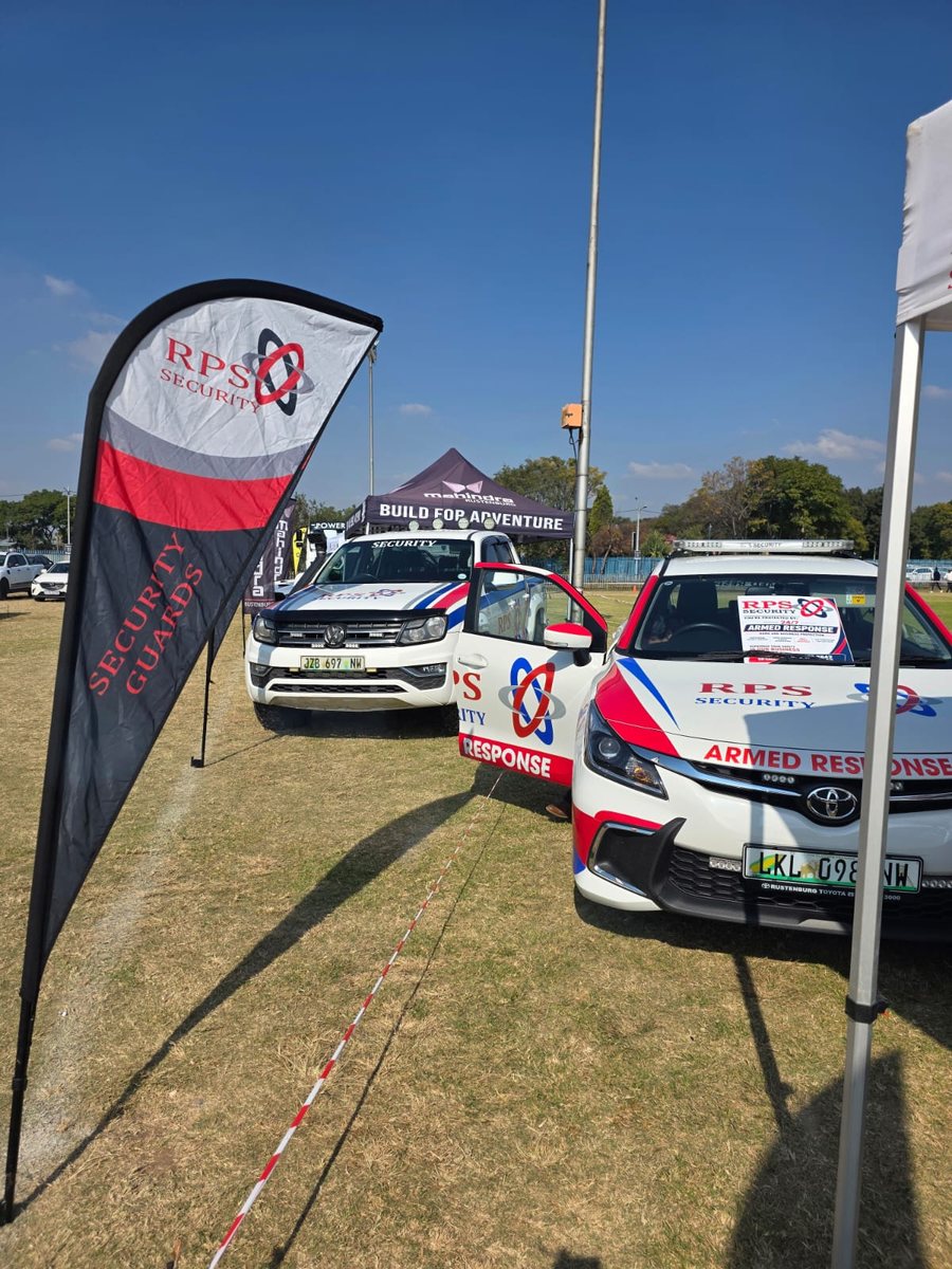 An RPS Security armed response vehicle and branded flag deployed at a Rustenburg community event